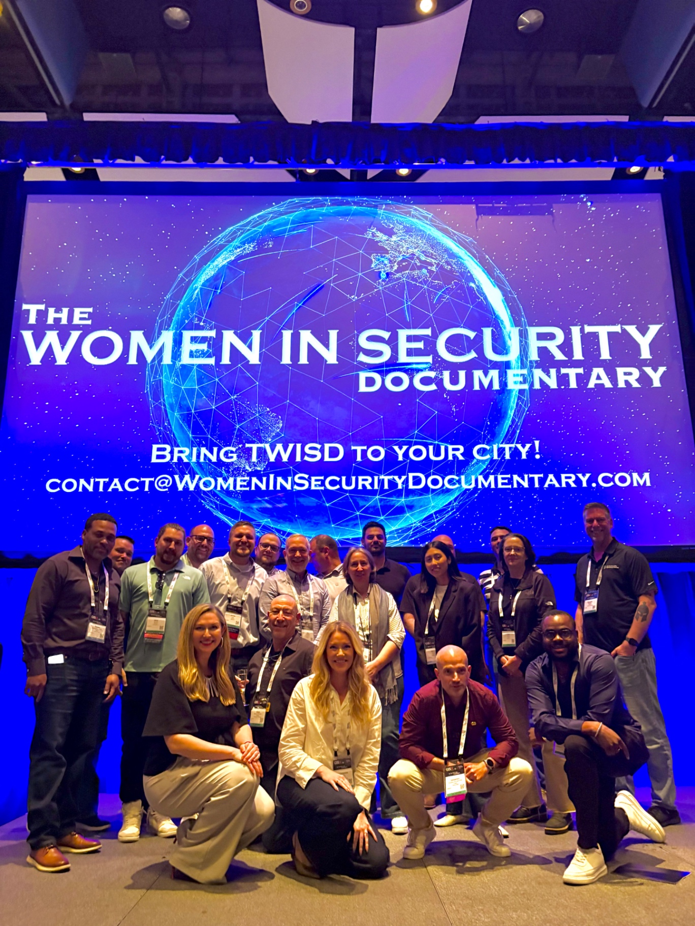 A group gathered on a conference stage after a screening event.